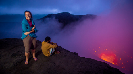 two-people-standing-at-edge-of-mt-yasur-volcano-watching-explosive-lava